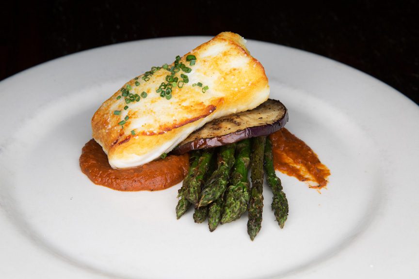 Lucky’s Restaurant’s roasted halibut with grilled eggplant and asparagus on top of a Romesco sauce is an explosion of flavor. Photos by Brandon Scott.