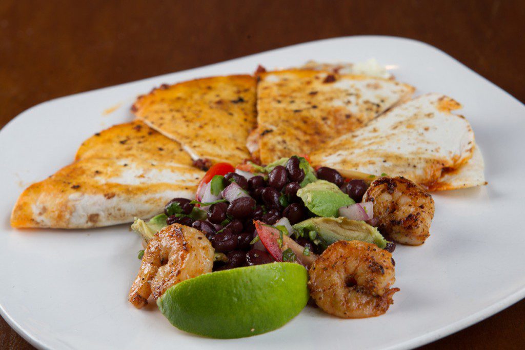 Take a big bite of the chorizo quesadilla with shrimp, an appetizer at Urban Roots. Photo by Brent Fuchs.