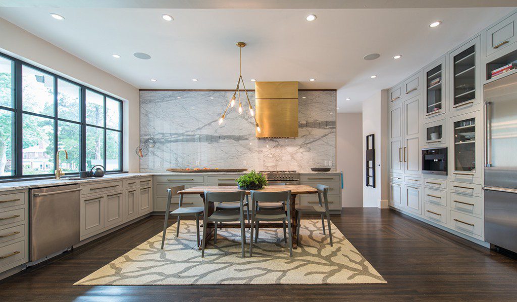 The centerpiece of the kitchen is a ceiling-high backsplash that was added to use up marble slabs. Photo by Nathan Harmon.