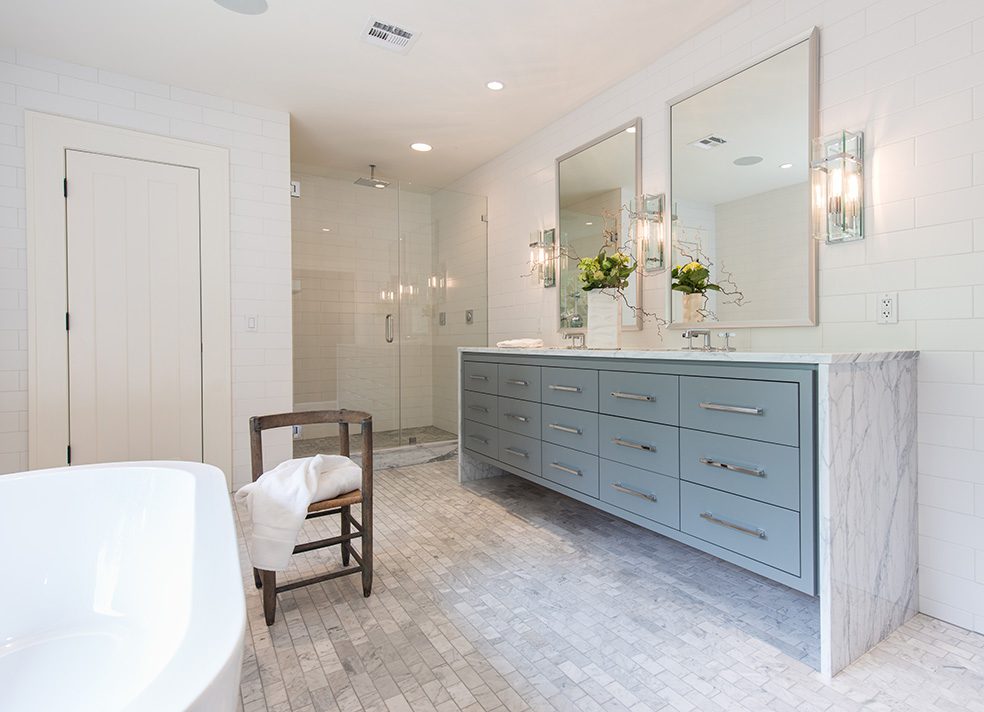 The large, custom designed vanity is topped with Statuario marble in a waterfall design. Photo by Nathan Harmon.