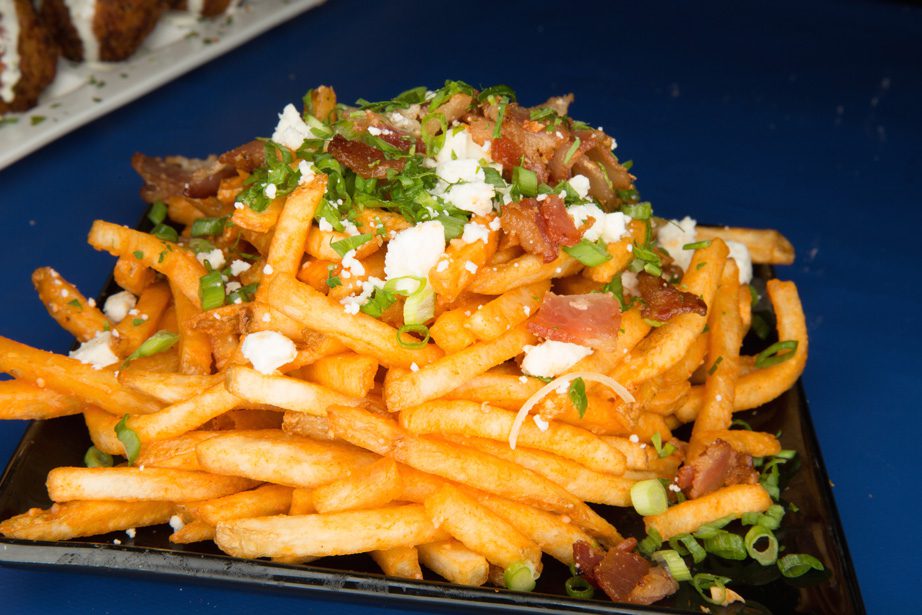 Buffalo fries are topped with buffalo sauce, bleu cheese, bacon and green onions. Photo by Brandon Scott.
