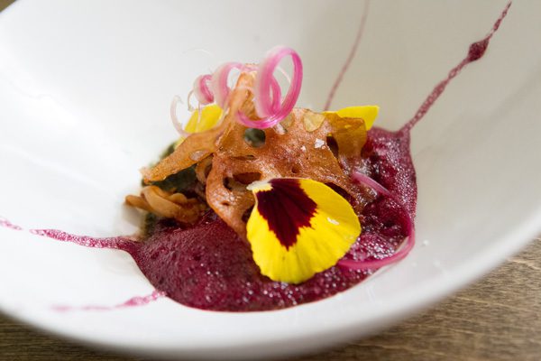 Squid is served on beet foam at Nani. Photo by Brent Fuchs.