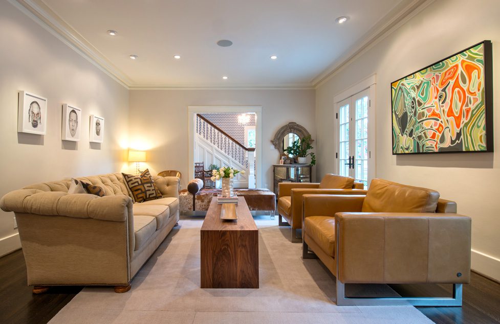An existing sofa was used and new leather chairs purchased for the living area. Three pencil drawings by Tim Moore of rap stars are the conversation starters in the room.