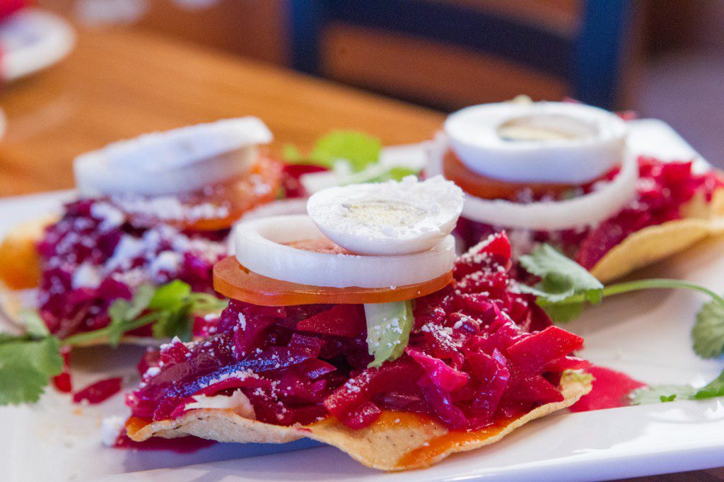 Guatemalan Enchiladas are topped with a choice of meat, pickled beets and other garnishes. Photo by Brent Fuchs.