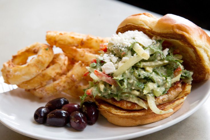 Johnnie the Greek, a chicken burger, is served with olives and onion rings at Urban Johnnie. Photo by Brent Fuchs.