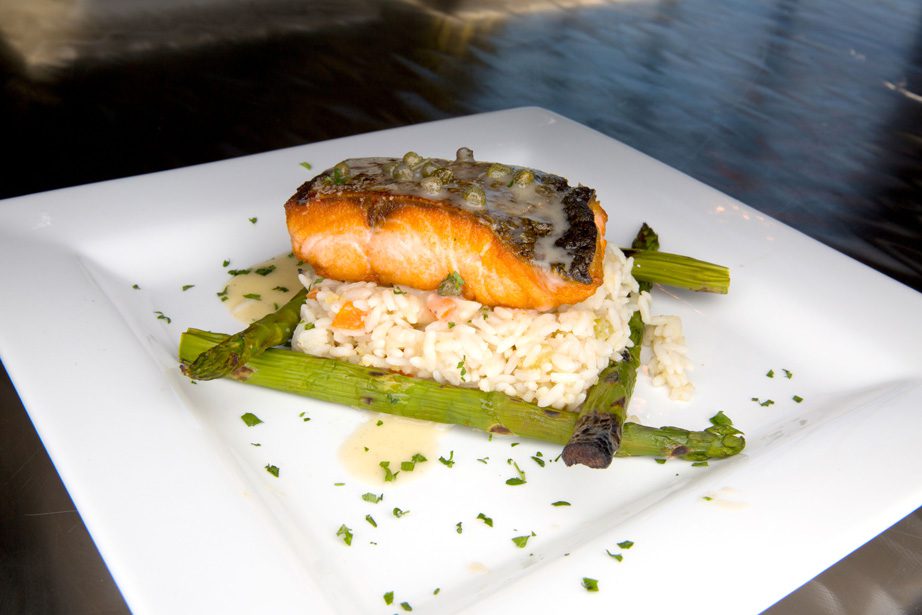 Pan Saumon Poele features pan-seared salmon over rice pilaf served with lemon caper buerre blanc and asparagus. Photos by Brandon Scott.