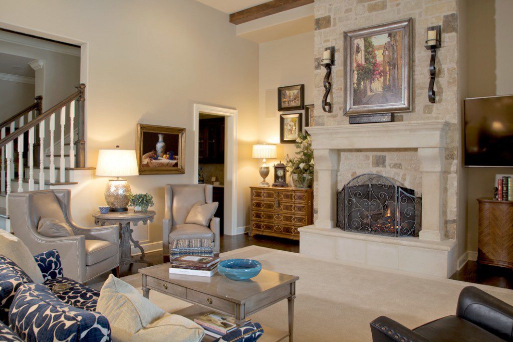Taupe leather wingback chairs, a sofa and blue leather lounge chair create a cozy seating area around the room’s fireplace. Photos by Rick Stiller.