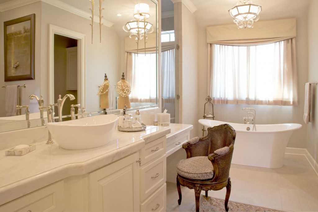 Limestone flooring and the freestanding tub keep the space feeling light and airy. 