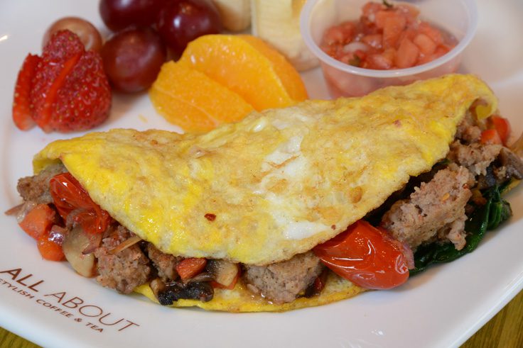 The sausage omelet is packed full with grilled vegetables and cheese and served with fresh fruit and salsa on the side. Photo by Natalie Green. 