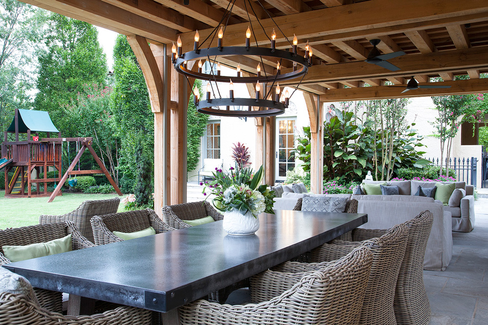 This outdoor space was designed by Tulsa-based architecture firm, Austin Bean. Inset: Phantom mosquito screens can be used to block out the sun and pesky insects. Photo by Jenifer Jordan