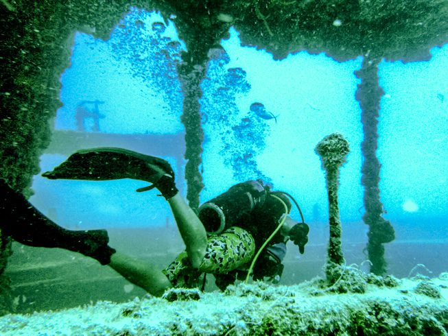 A diver explores the deck of the Thunderbolt – a 188-foot ship sunk in 1986 to create this dive spot 120 feet beneath the surface. photos by Viuf Photography.