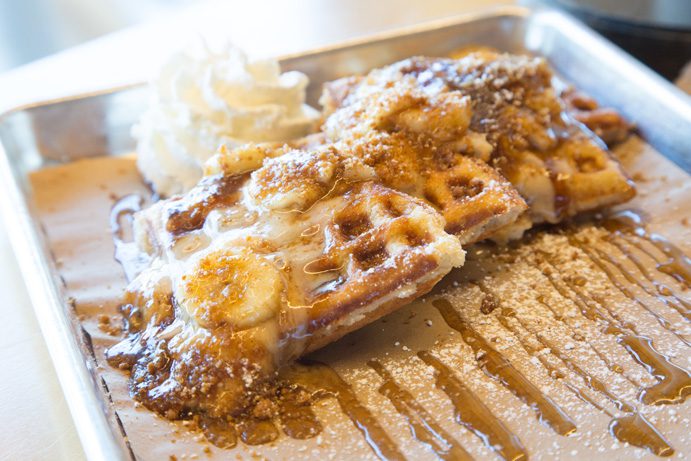 A crispy waffle is topped with brown sugar, rum bananas and fluffy whipped cream. Photo by Brent Fuchs.