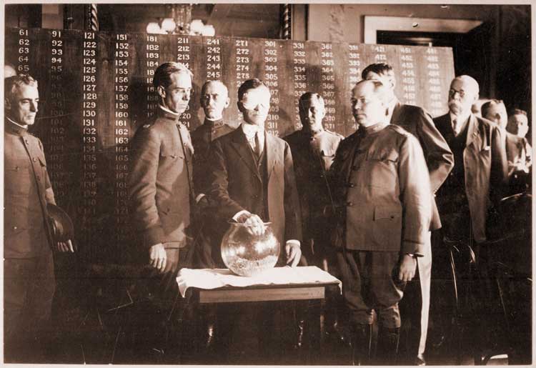Secretary of War Newton Baker draws the first number of the lottery created by the 1917 Selective Draft Act.