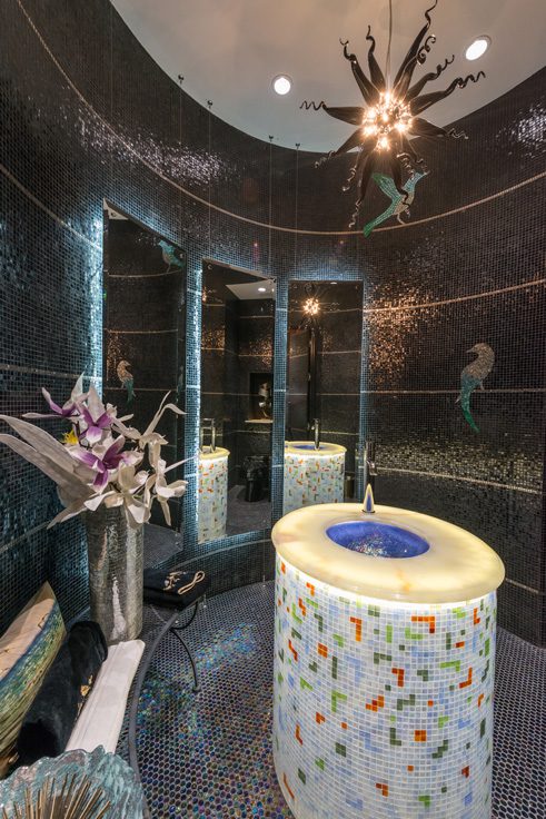 Platinum tile runs around the interior of the guest bath. 