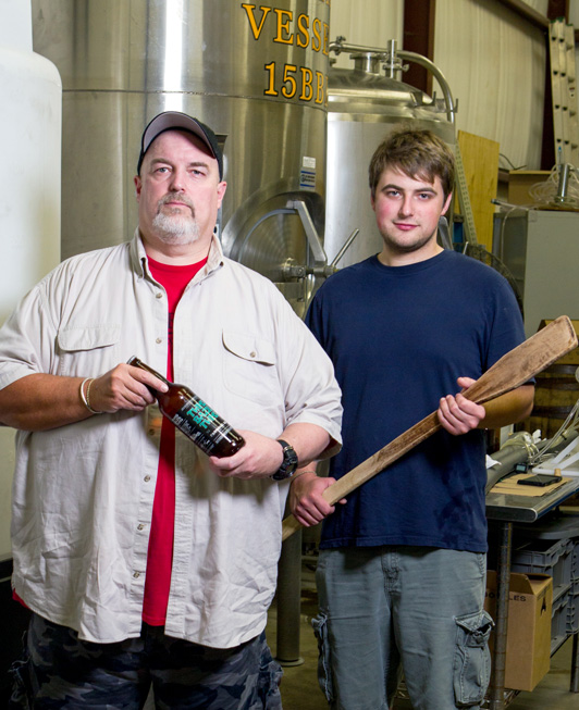 Mike Sandefur, pictured with his son, Jordan, is owner and brewmaster of battered boar. Photo by Brent Fuchs.