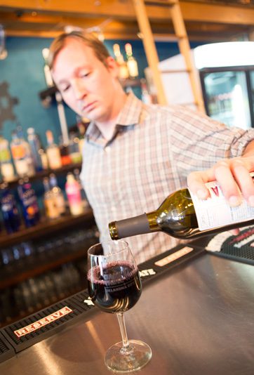 One of Urban Wineworks’ experienced bartenders pours a glass of wine. photos by Brent Fuchs.