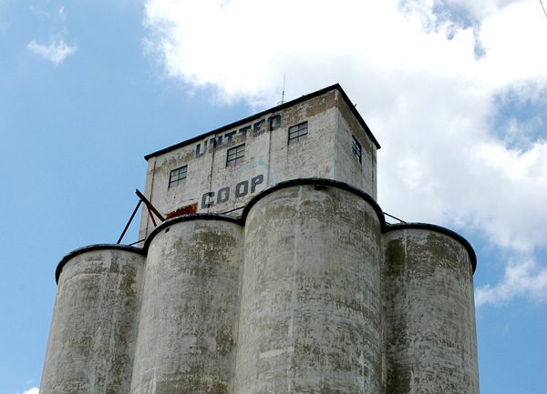 A grain elevator in Oklahoma, which has lost its original paint, shows its age.