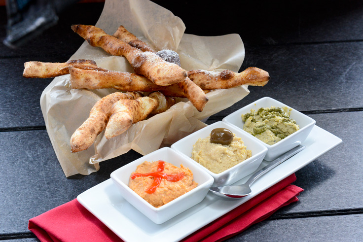 The hummus trio – pesto, garlic and roasted red pepper – is served with house-made bread sticks. Photo by Natalie Green.