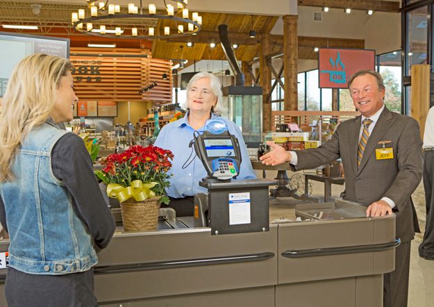 Jeff Reasor assists a customer at Reasor’s Foods at 41st and Peoria. Photos by Scott Miller.