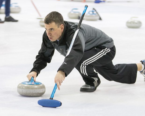Keith Hudson sends his stone down the ice at a recent gathering of the Oklahoma Curling Club. Photo by Brent Fuchs.