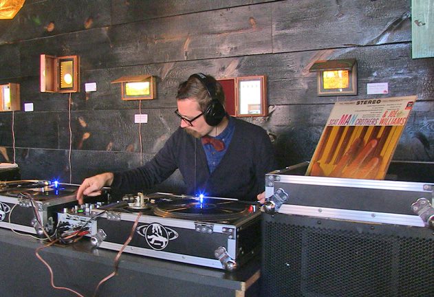 dj evan thomas spins one of the community’s favorite vinyl records at Chimera cafe.