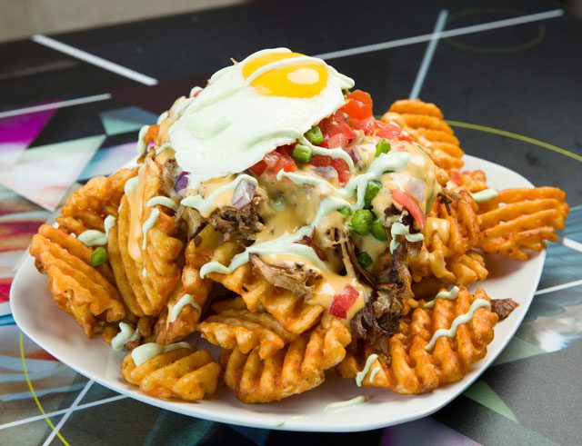 Tequila sunfryz is Guyutes most popular menu item: waffle fries, tequila pulled pork and a sunny-side egg, topped with cilantro crema. photos by Brent Fuchs.