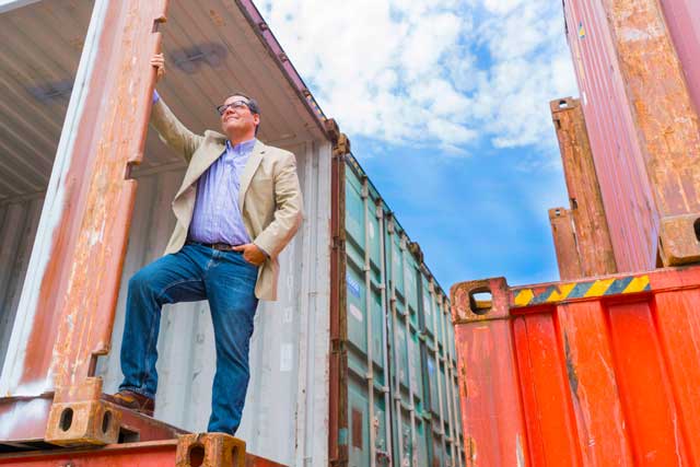 Casey stowe with the shipping containers that will house the stores at The Boxyard.