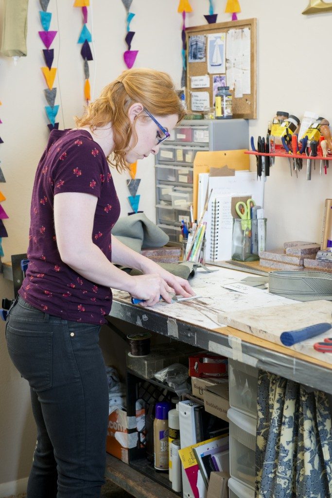 Emily Blackburn carefully cuts leather for her customized creations. Photos by Natalie Green