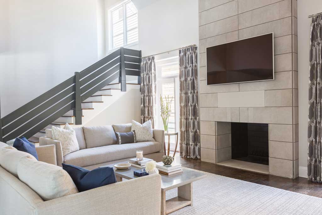 New windows in the family room provide natural lighting, accenting the seating area and new fireplace. A secondary stair was added to access the new upstairs game, exercise and craft rooms and renovated bedrooms. Photo by Alyssa Rosenheck.