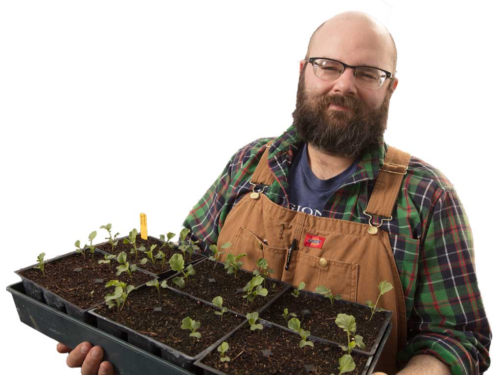 Mason Weaver of The Regional Food Bank of Oklahoma spends time in the organization’s greenhouse to have plants ready for the spring. Photo by Brent Fuchs.