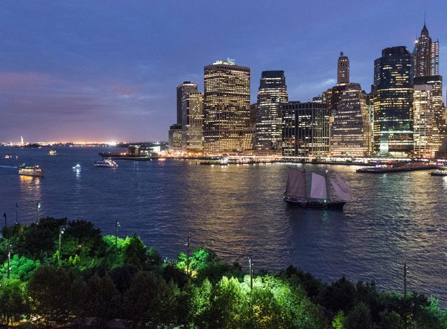 holds its own cobblestone charm apart from the skyline visible across the Hudson River. © NYC & Company/Julienne Schaer.