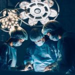 Surgeons team working with Monitoring of patient in surgical operating room. breast augmentation