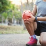 runer woman with knee injury and pain