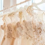 wedding dresses hanging on racks