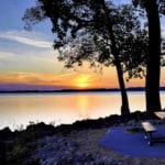 Travel trailer camping by the Mississippi river at sunset in Tho